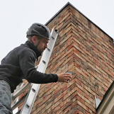 Chimney sweeps inspect a chimney at home in Peachtree Corners GA