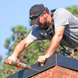 Chimney crew installing rain pan in Dunwoody GA